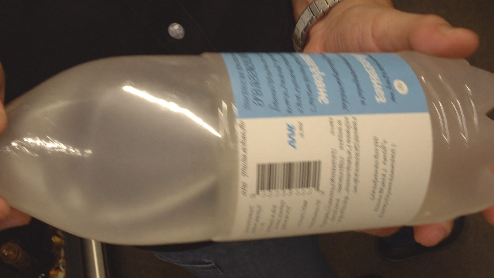 Phone scanning a frosted curved bottle showing why food scanner app accuracy drops